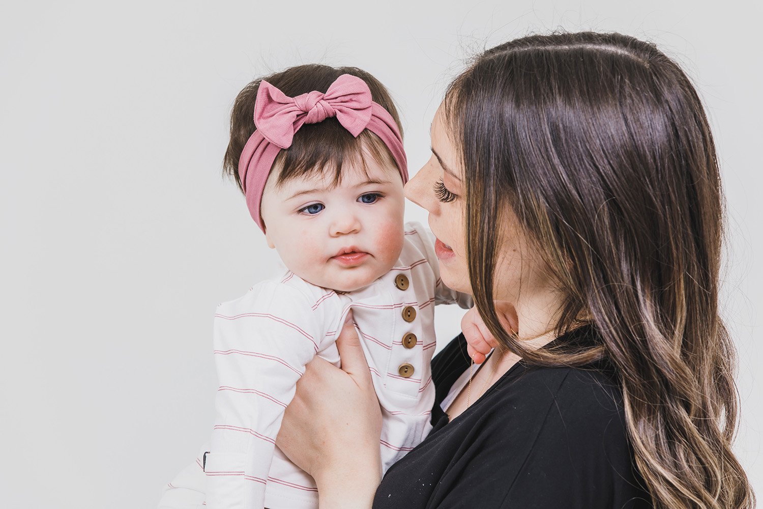 A soft and stretchy knotted bow accessory for babies, showcasing its stylish design and comfortable fit.