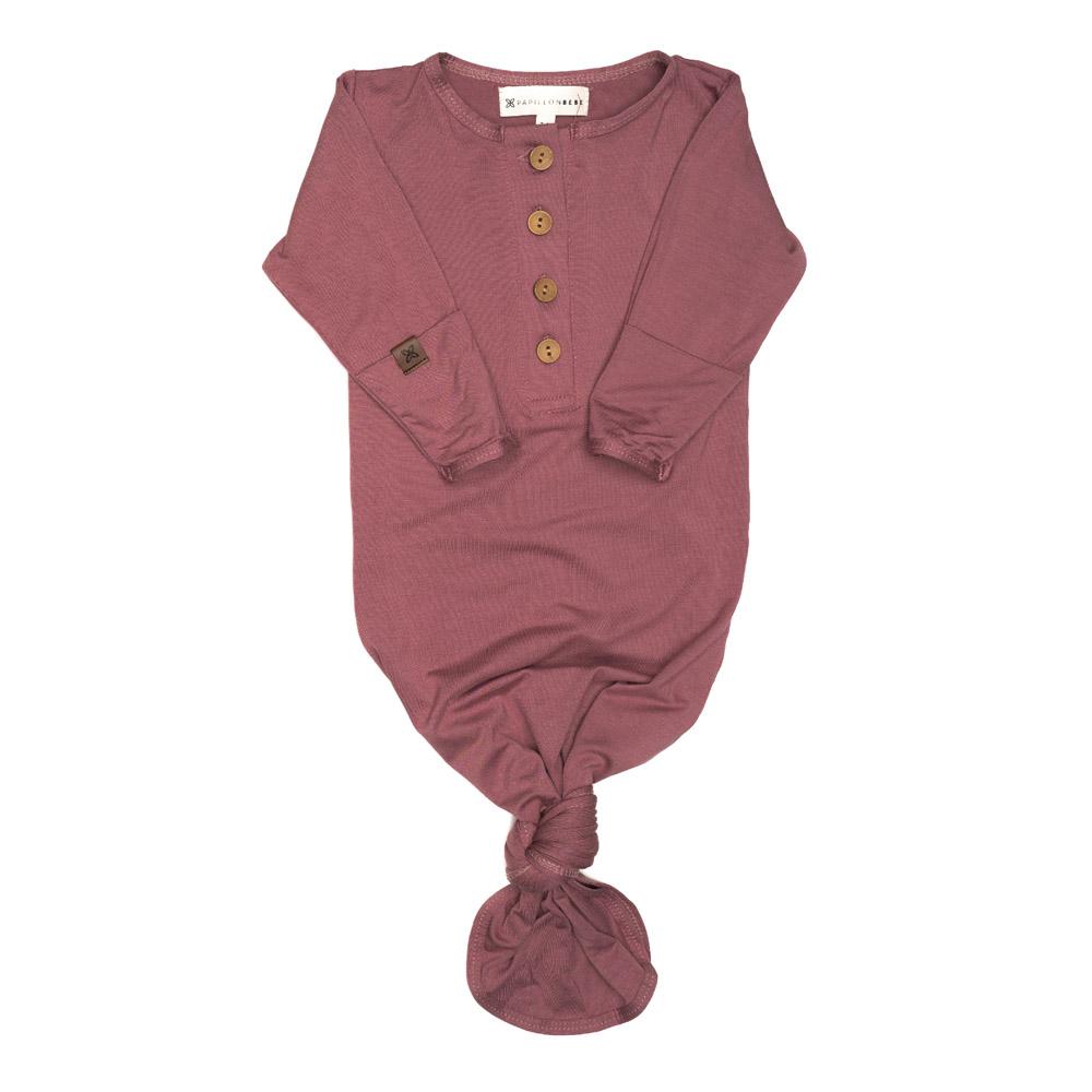 A soft and stylish knotted gown for babies, featuring functional buttons and a cozy design, perfect for diaper changes.