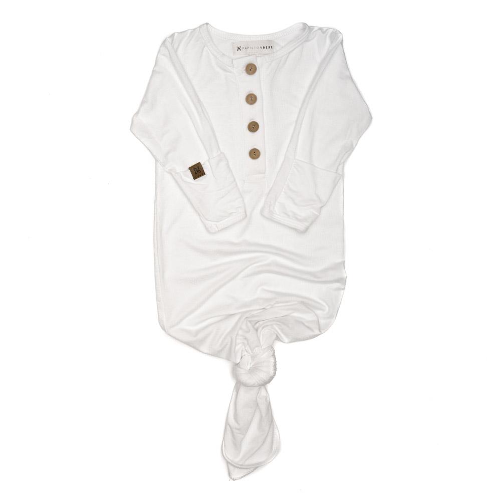 A soft and stylish knotted gown for babies, featuring functional buttons and a cozy design, perfect for diaper changes.