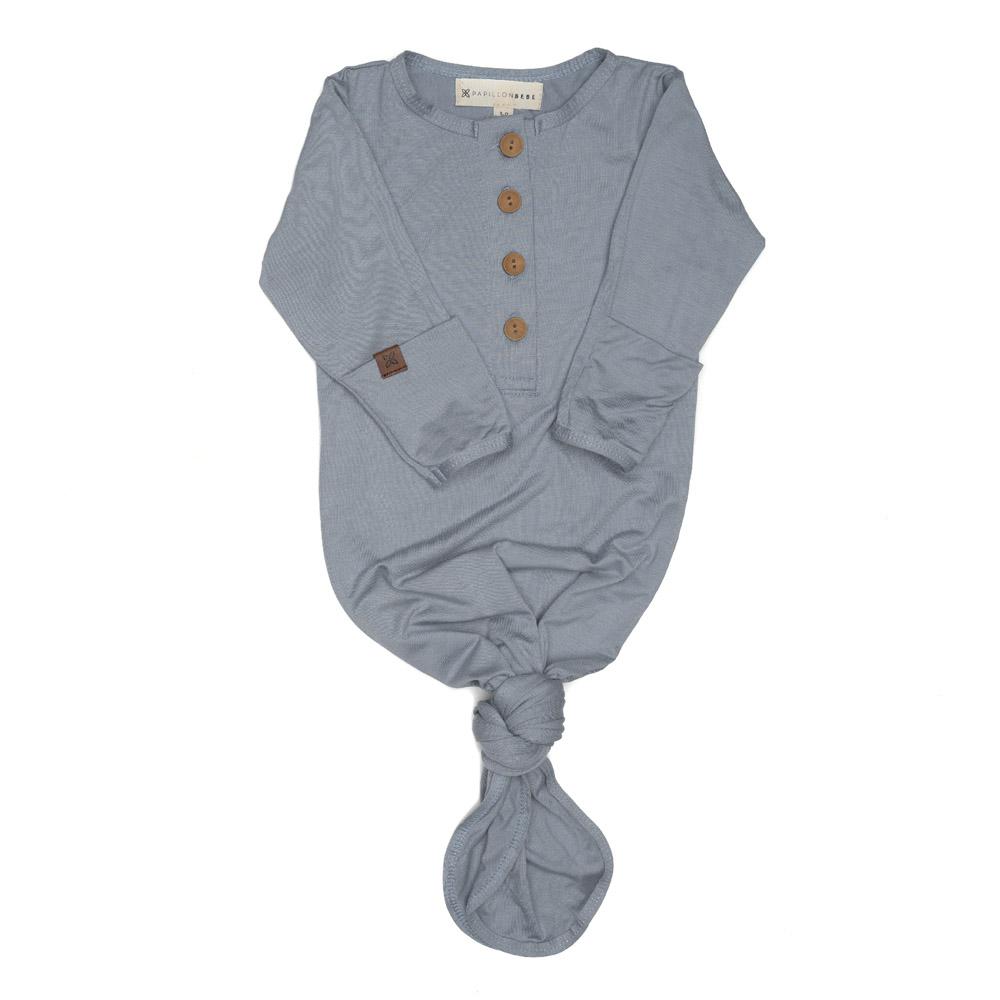 A soft and stylish knotted gown for babies, featuring functional buttons and a cozy design, perfect for diaper changes.