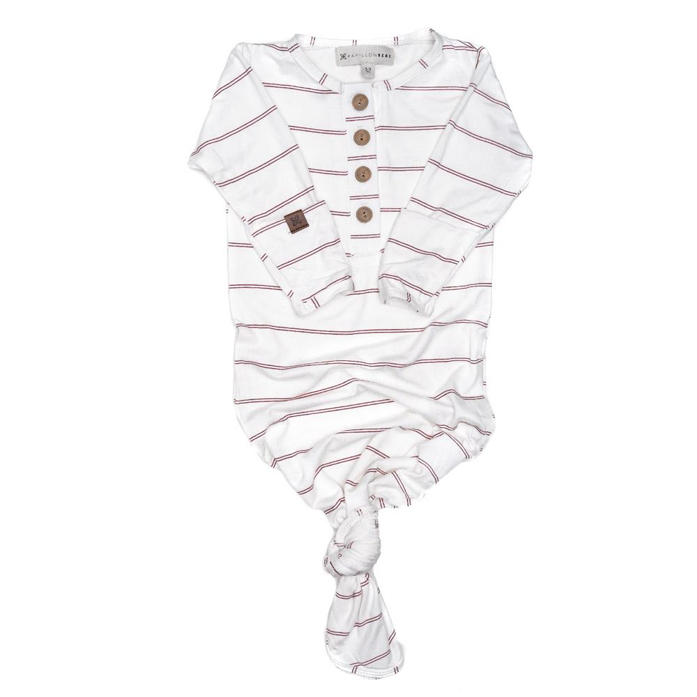 A soft and stylish knotted gown for babies, featuring functional buttons and a cozy design, perfect for diaper changes.