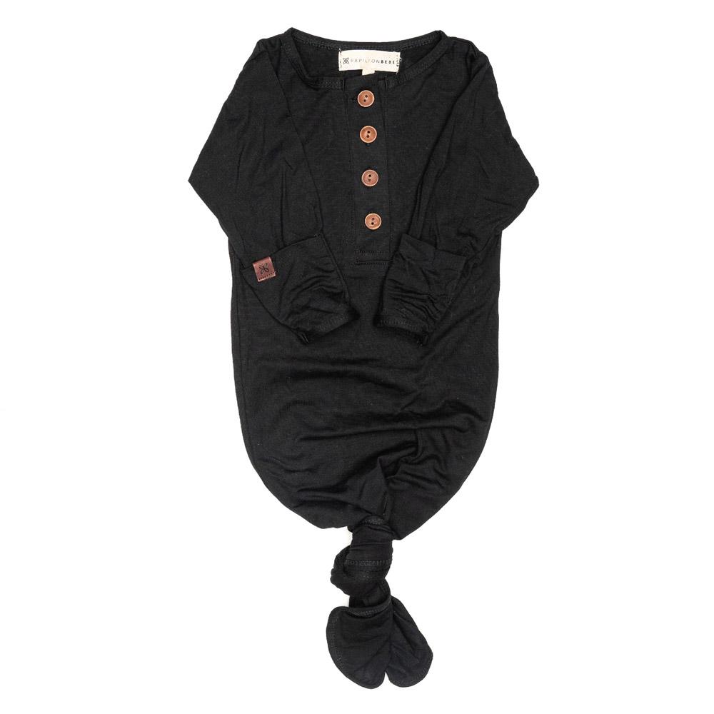 A soft and stylish knotted gown for babies, featuring functional buttons and a cozy design, perfect for diaper changes.