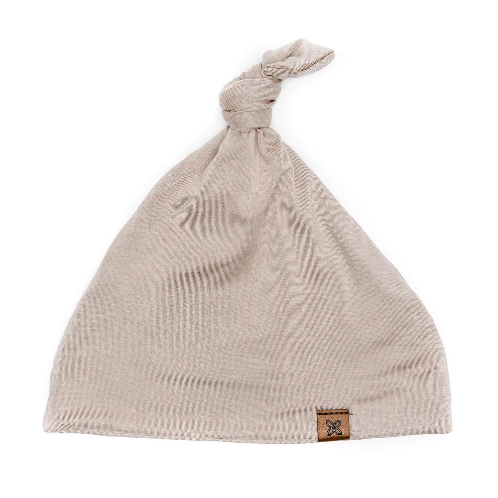 A soft, stylish knotted hat for babies, featuring a cute knot on top and made from a gentle fabric blend, perfect for keeping little heads warm.