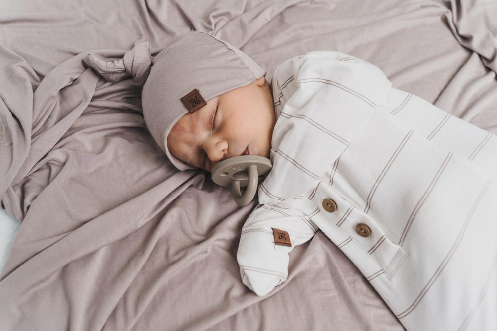 A soft, stylish knotted hat for babies, featuring a cute knot on top and made from a gentle fabric blend, perfect for keeping little heads warm.