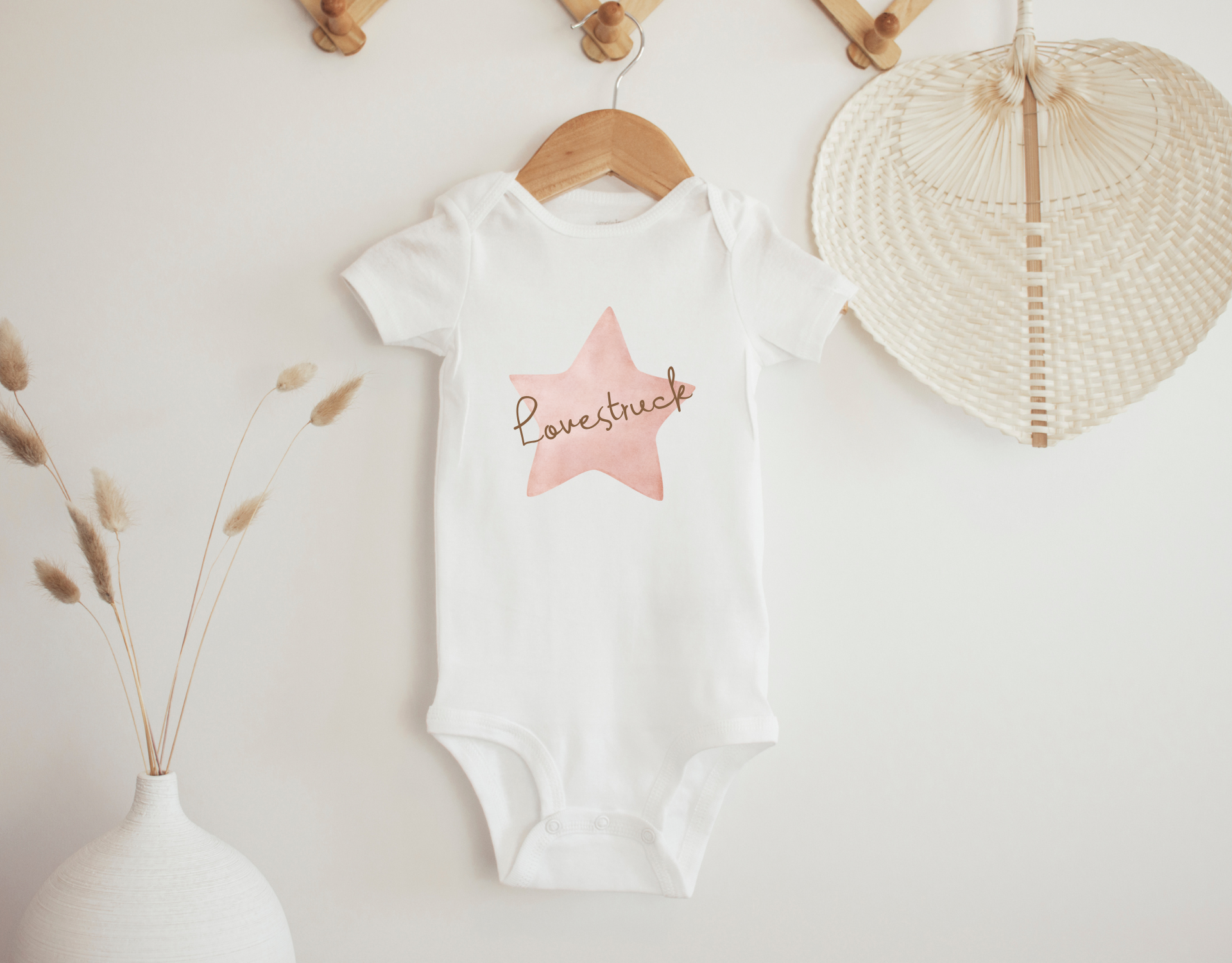 Lovestruck Bodysuit for newborns, featuring a cute design and made from 100% cotton, perfect for babies.