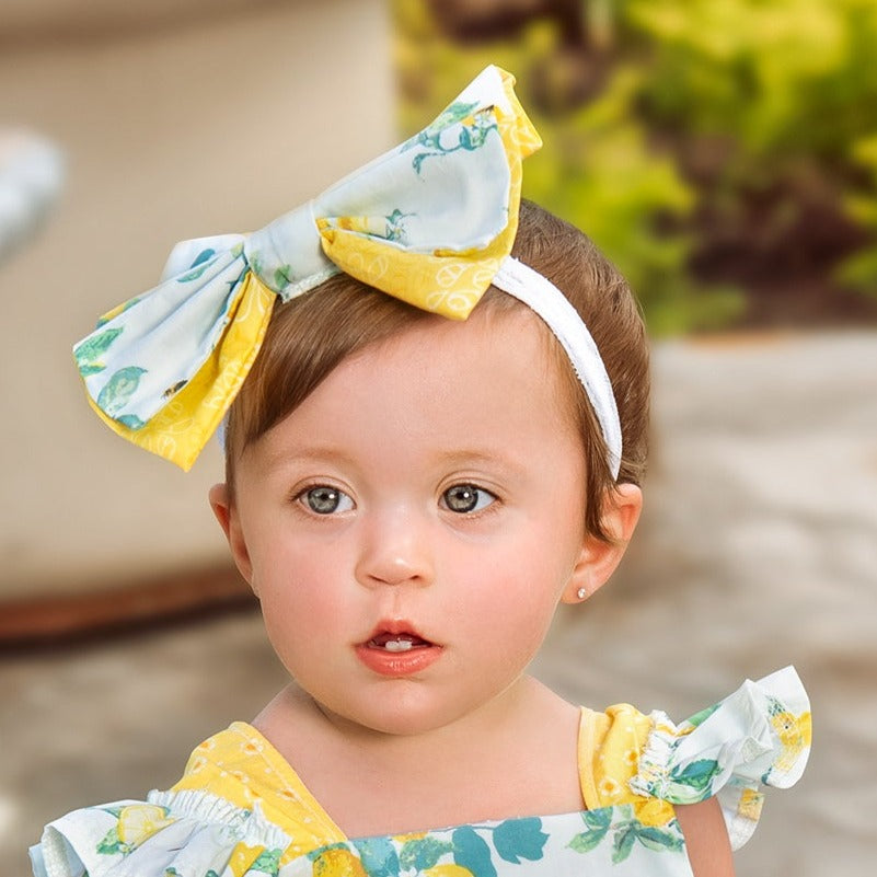 Lucy's Lemonade Headband featuring a vibrant lemonade-inspired design, perfect for casual and sporty looks.