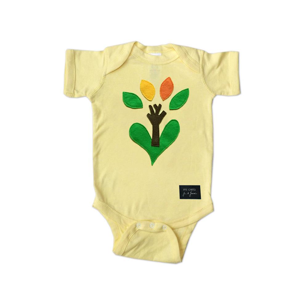 A vibrant yellow onesie featuring unique felt appliqué designs, handmade and hand-stitched for boys, showcasing creativity and quality craftsmanship.