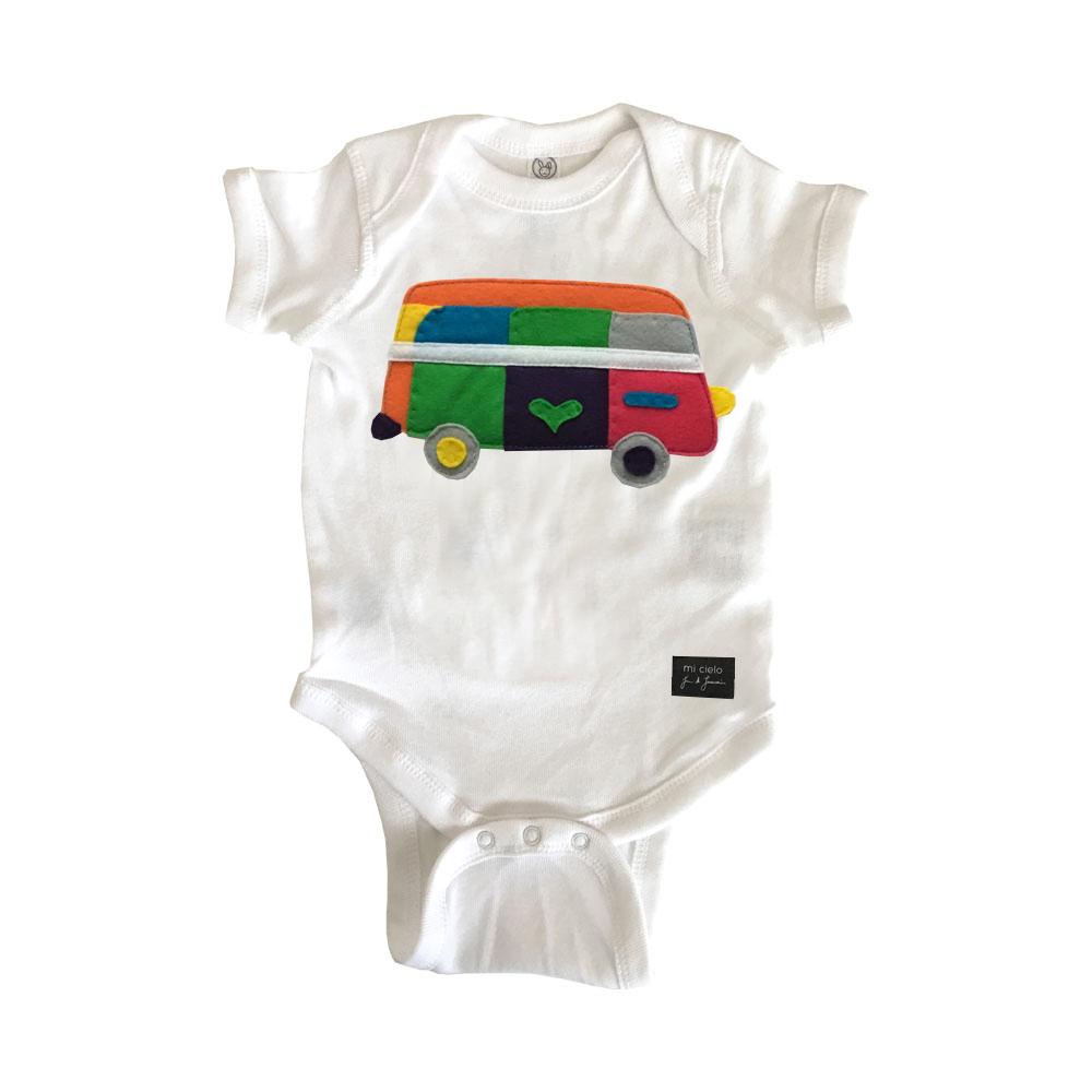 A handmade white infant onesie featuring unique felt appliqué designs, crafted with love in a collaboration with JUAN DE LASCURAIN.