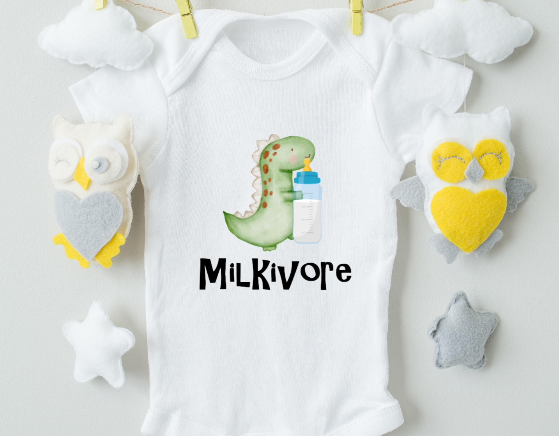 Milkivore Bodysuit made of 100% cotton with a unique heat transfer vinyl design, featuring an expandable neckline and front snap closure.