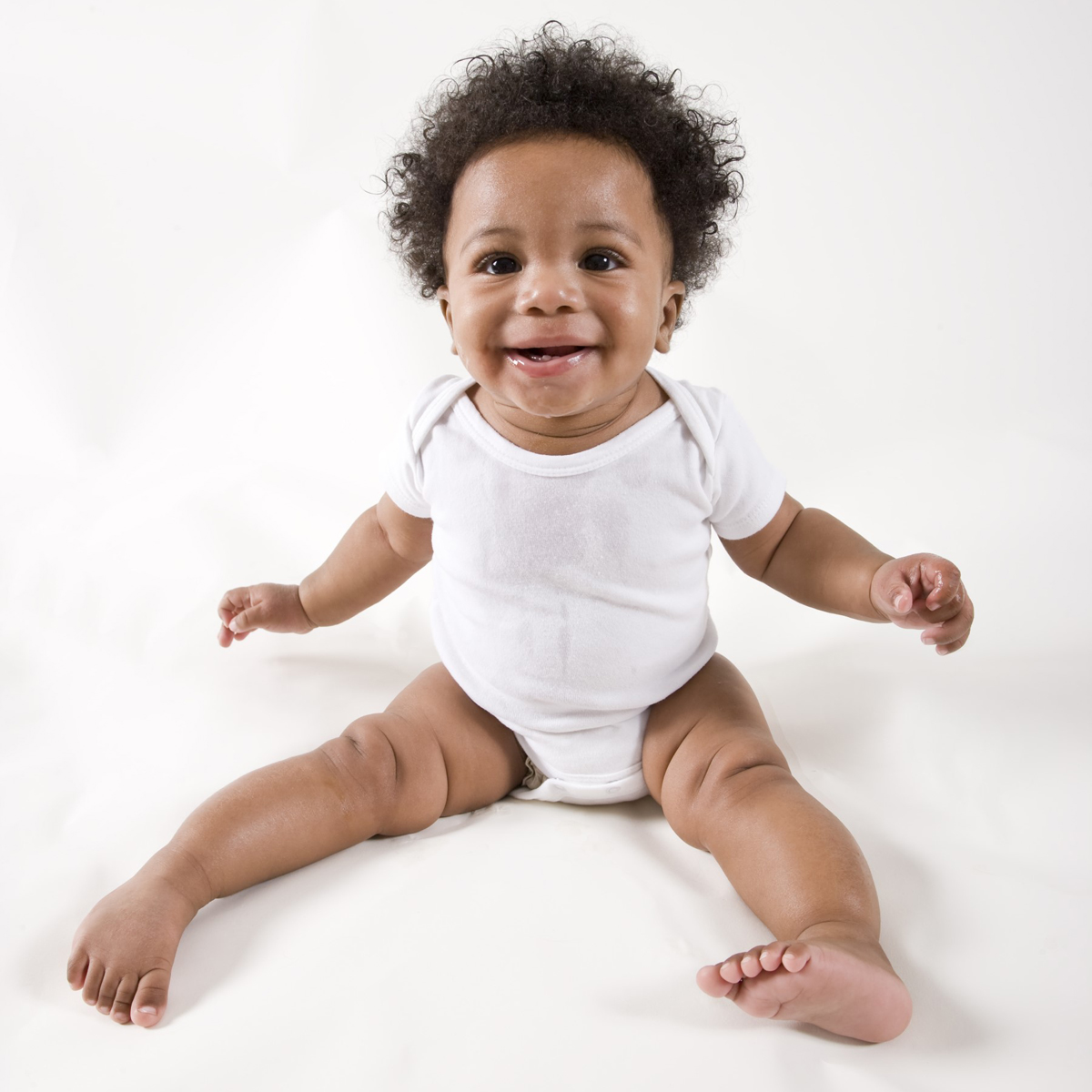 Newborn baby boys 7 pc layette set featuring soft cotton clothes, white booties, and expandable neckline for easy dressing.