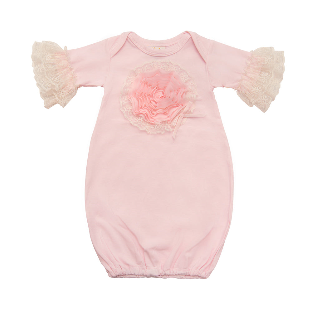 A soft pink newborn gown designed for girls, featuring a comfortable fit and adorable style, perfect for sleep and play.