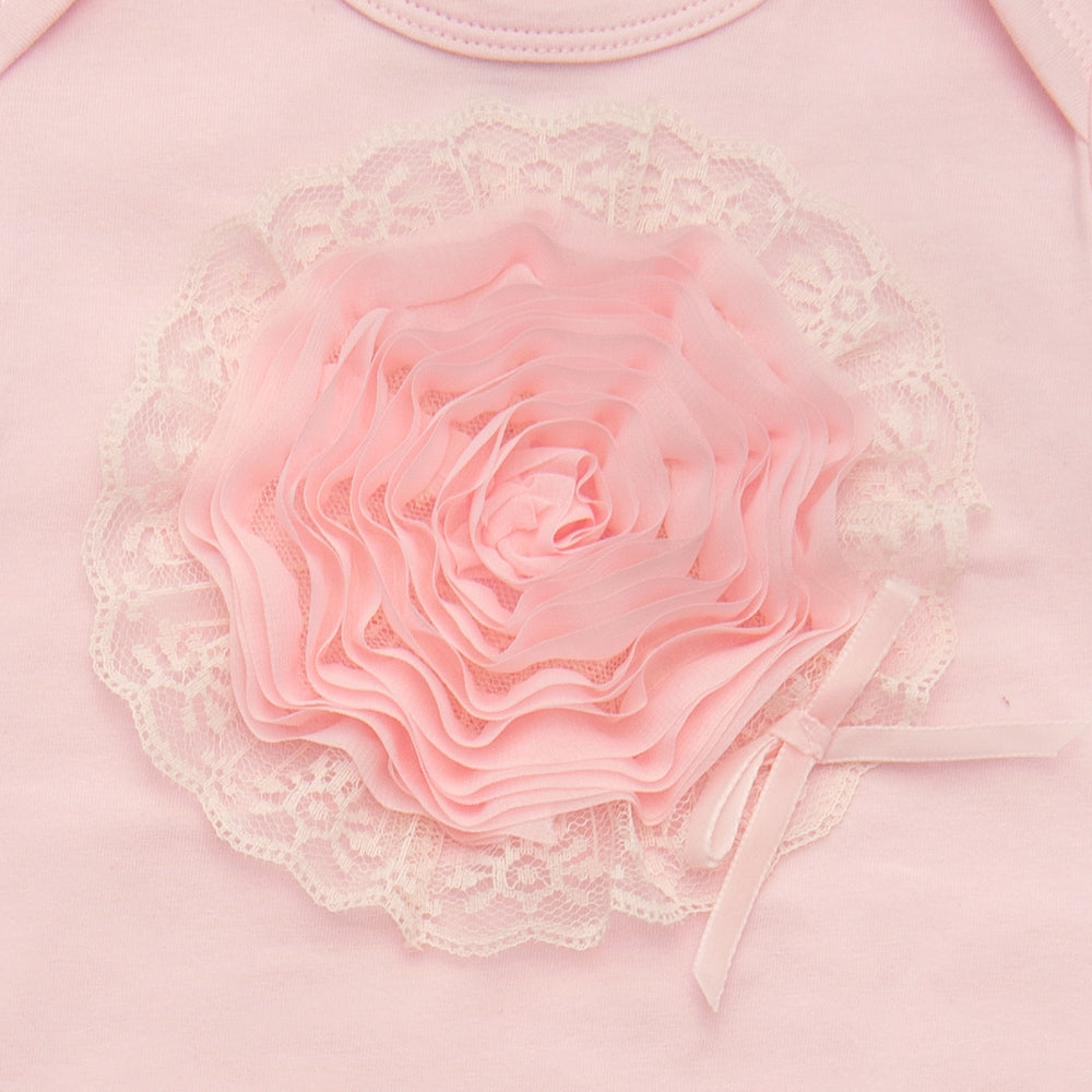 A soft pink newborn gown designed for girls, featuring a comfortable fit and adorable style, perfect for sleep and play.