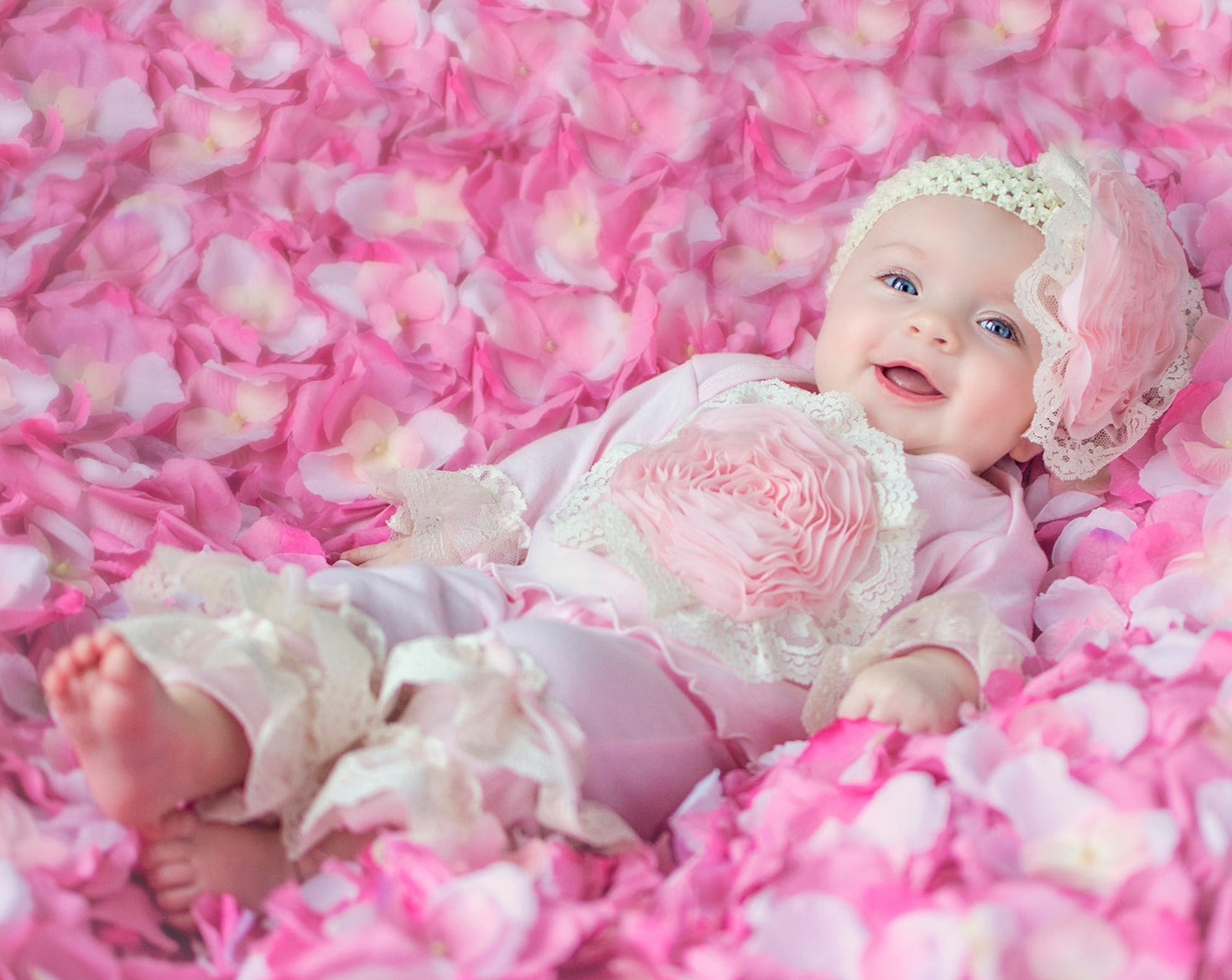 A soft pink newborn gown designed for girls, featuring a comfortable fit and adorable style, perfect for sleep and play.