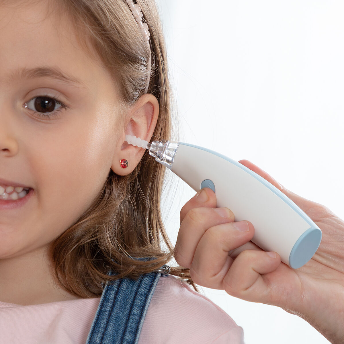 Child getting ear wax removed.