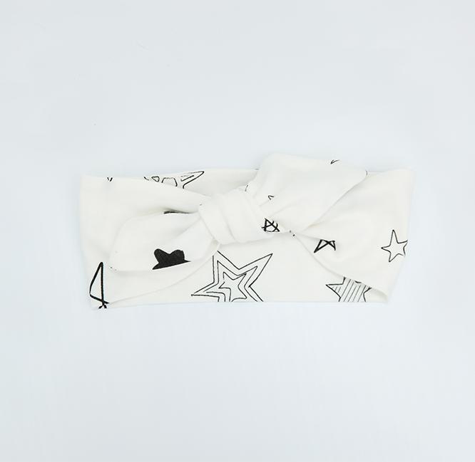 Adorable Stars Headband made from 100% GOTS organic cotton, featuring a cute star pattern, adjustable design for growing babies.