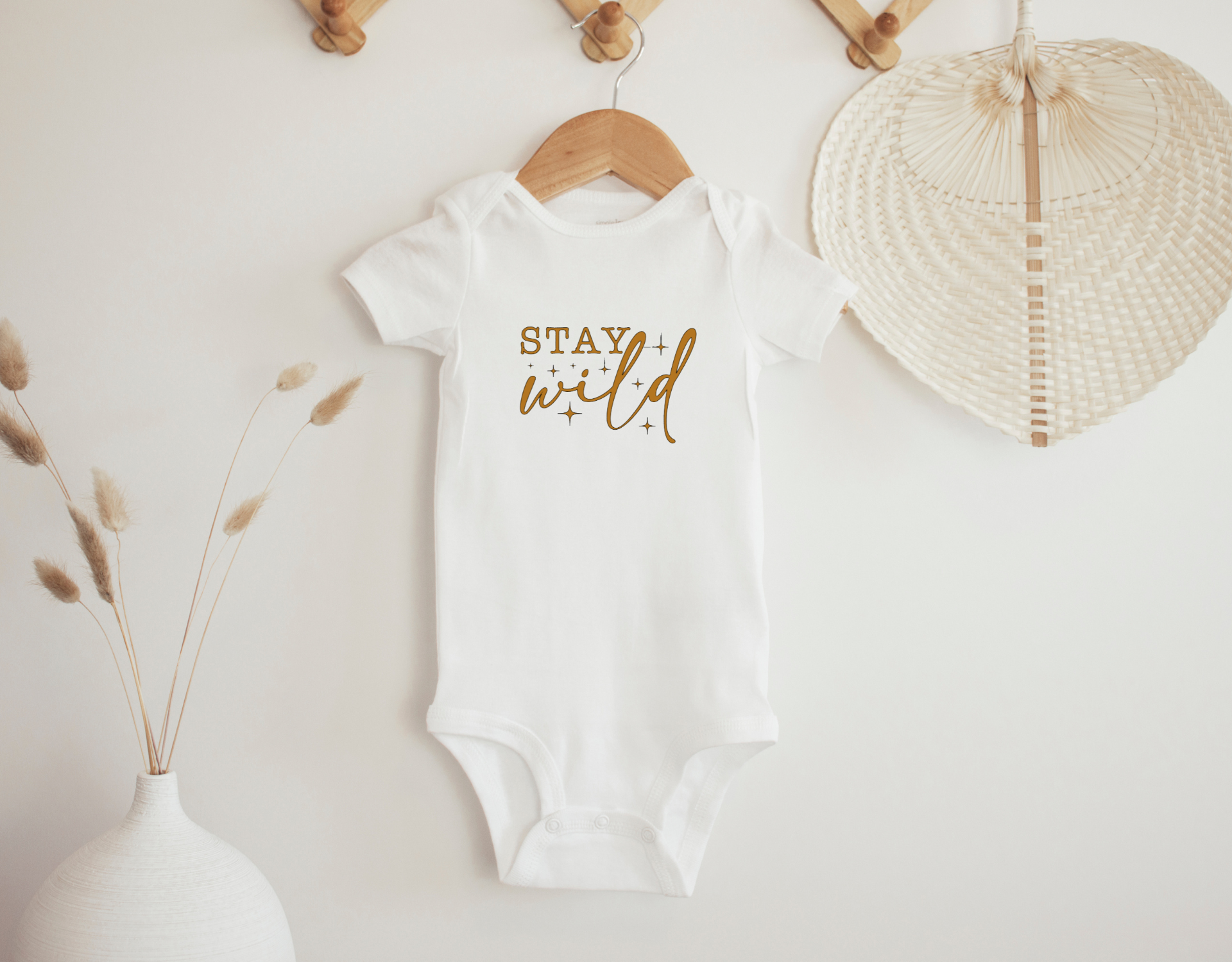 Stay Wild Bodysuit for newborns, featuring a cute design and made from 100% cotton, ideal for comfort and style.