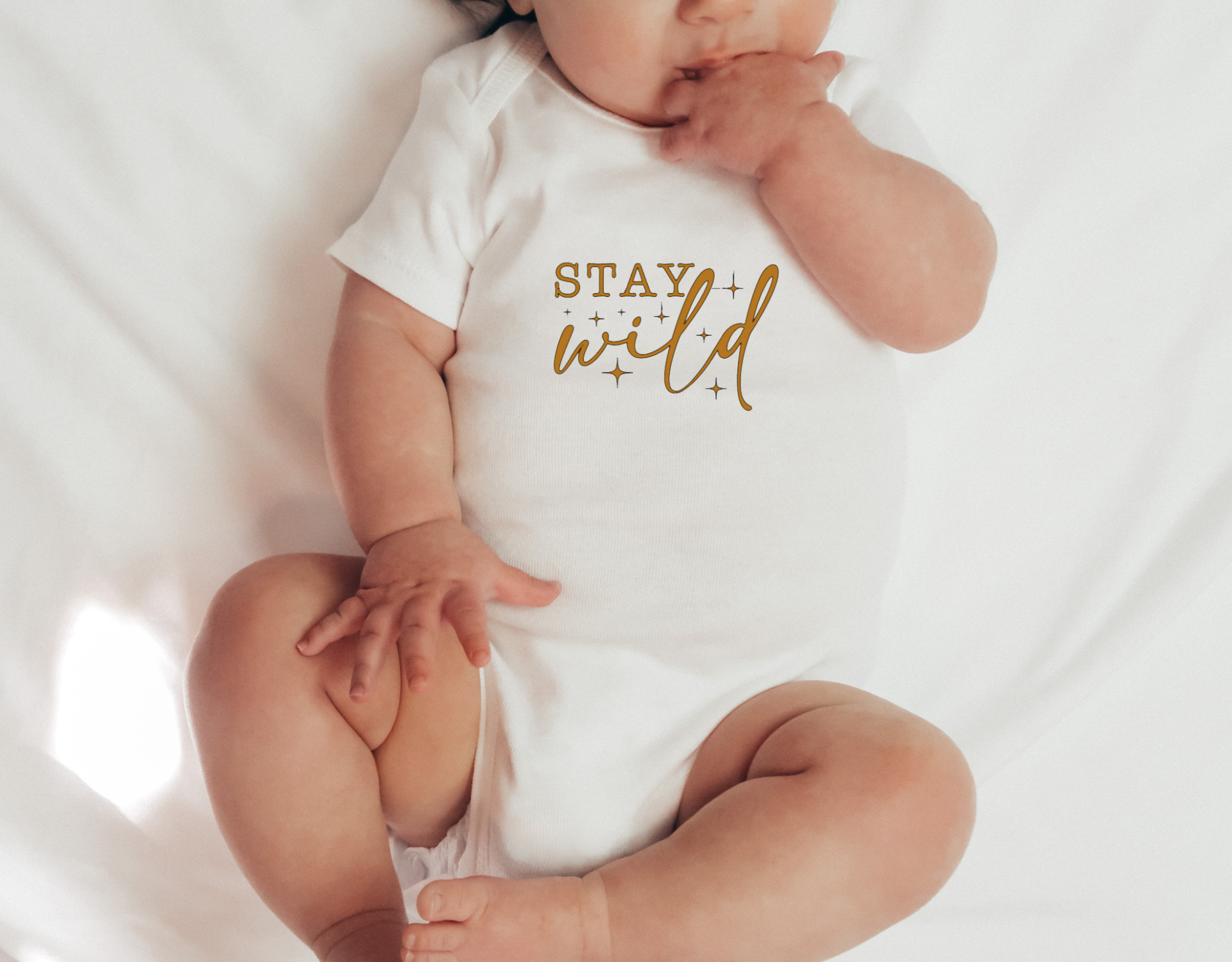 Stay Wild Bodysuit for newborns, featuring a cute design and made from 100% cotton, ideal for comfort and style.