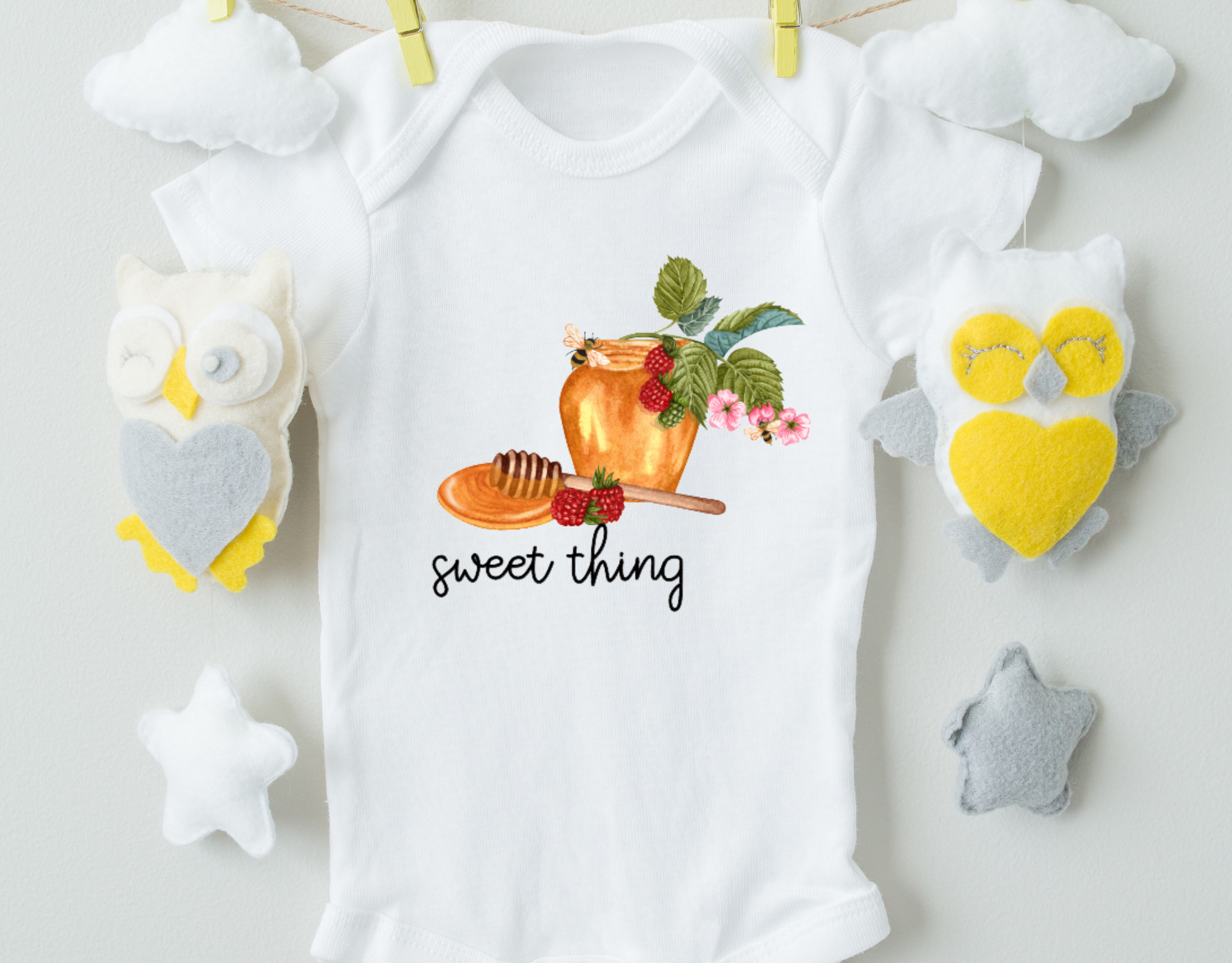 Sweet Thing Bodysuit made from 100% organic cotton with a professional heat transfer vinyl design, featuring an expandable neckline and front snap closure.