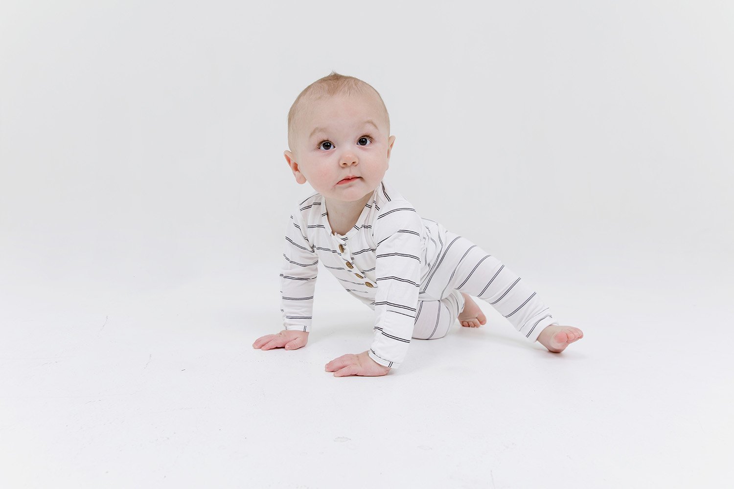 A cute baby outfit set featuring a soft fabric blend with functional wooden buttons, designed for comfort and style for infants.