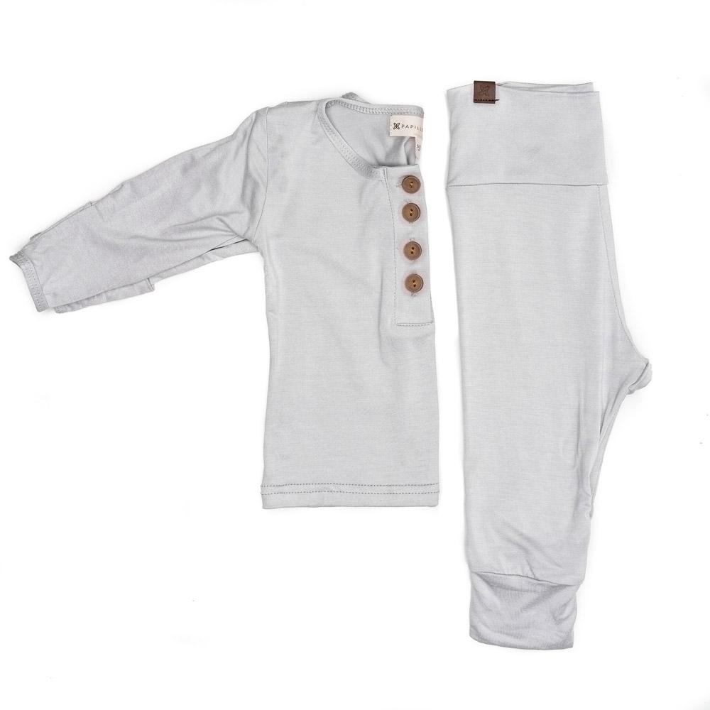 A cute baby outfit set featuring a soft fabric blend with functional wooden buttons, designed for comfort and style for infants.