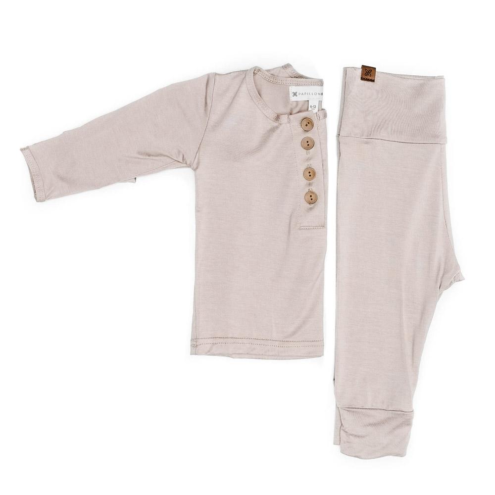 A cute baby outfit set featuring a soft fabric blend with functional wooden buttons, designed for comfort and style for infants.