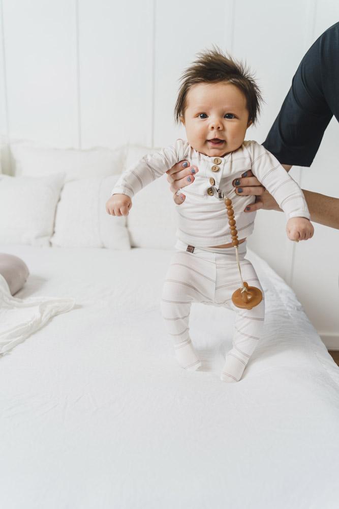 A cute baby outfit set featuring a soft fabric blend with functional wooden buttons, designed for comfort and style for infants.