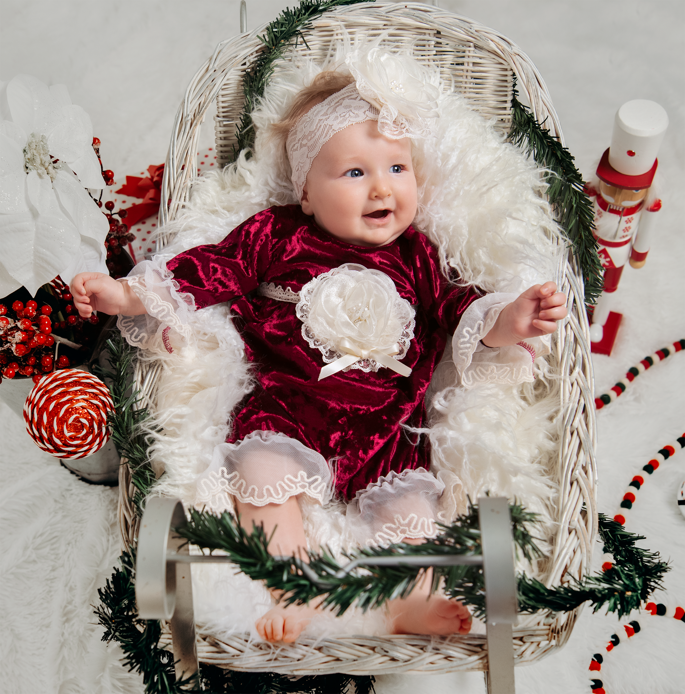 A luxurious Victoria Romper made of crushed velvet with delicate lace and trims, perfect for a baby's first holiday picture.