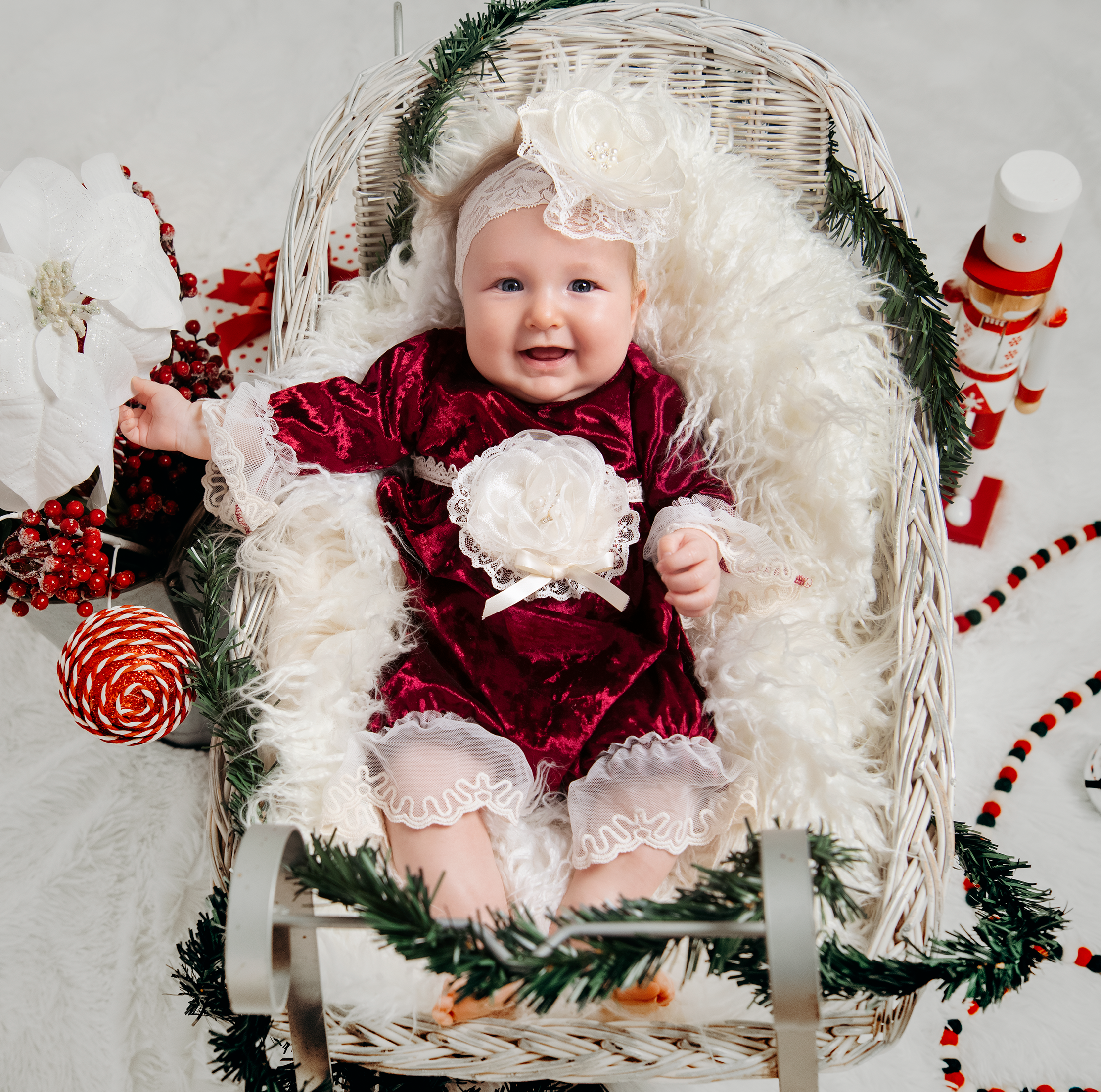 A luxurious Victoria Romper made of crushed velvet with delicate lace and trims, perfect for a baby's first holiday picture.