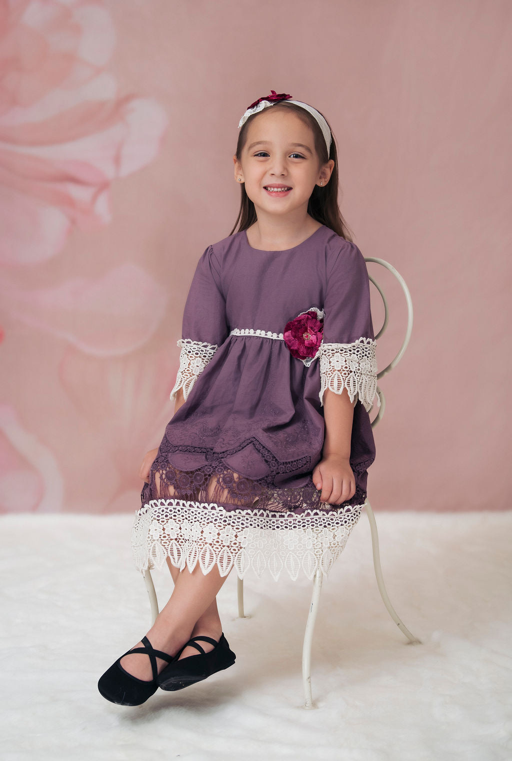 A beautiful Violet Field Dress featuring intricate crocheted lace and rich purple fabric, perfect for elegant occasions.