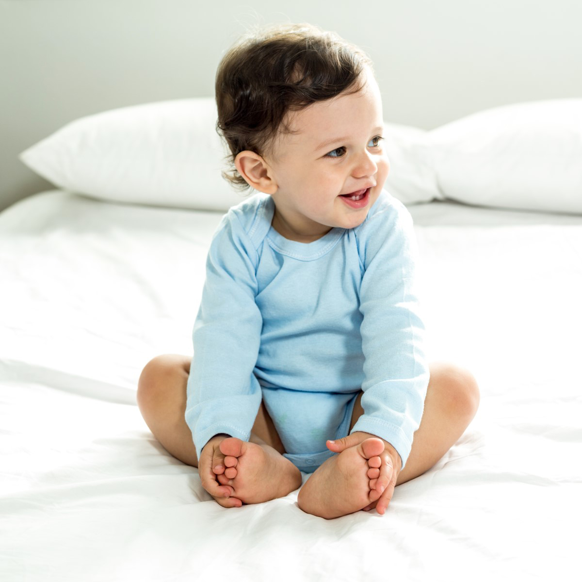 A pack of four white training pants made from soft cotton, designed for newborn comfort and easy changing.