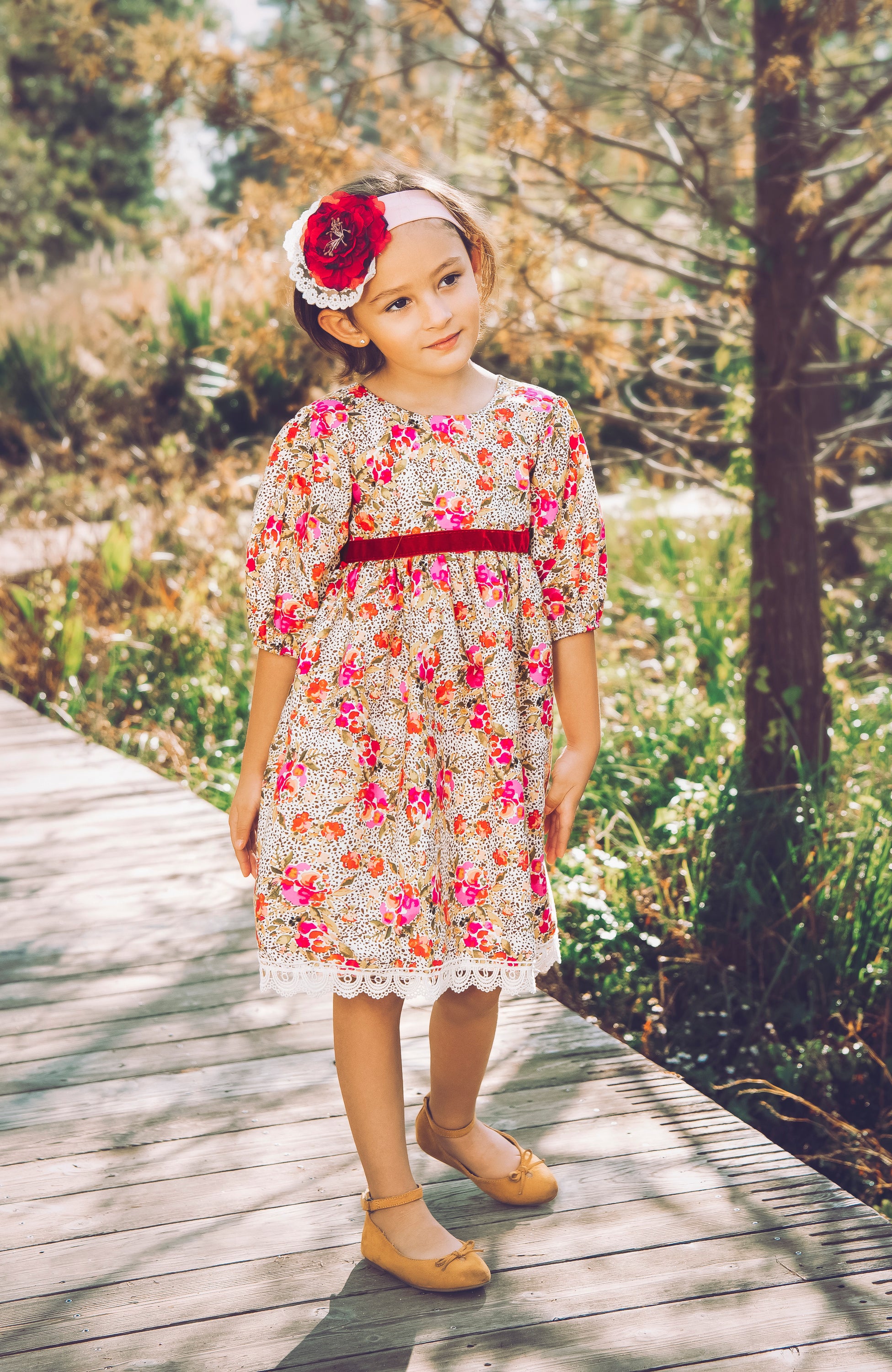 A vibrant Wild Bloom Dress featuring a stunning floral pattern in bright colors, perfect for summer occasions.