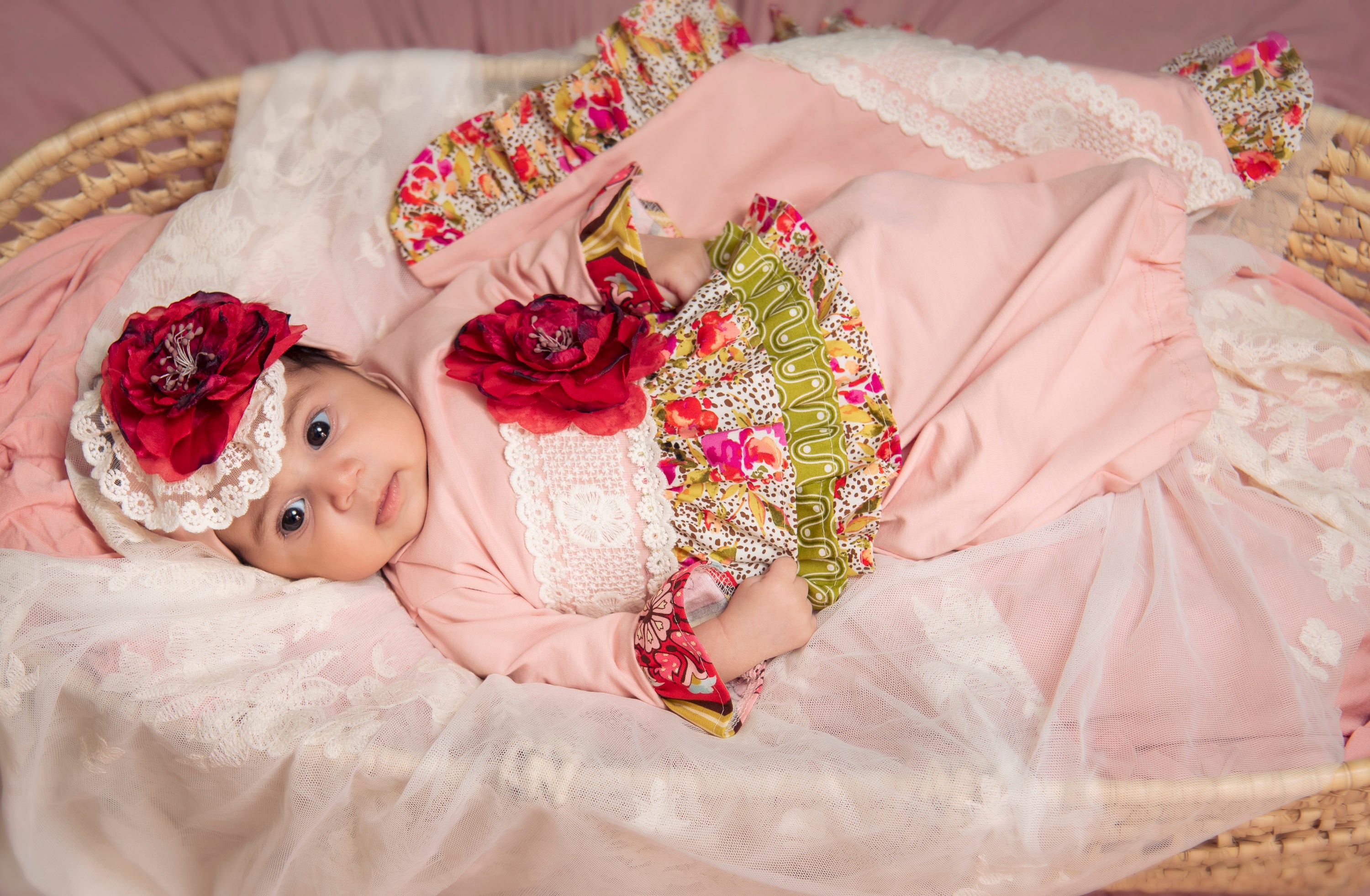 A vibrant Wild Bloom Gown featuring a beautiful floral pattern, perfect for newborns and infants.