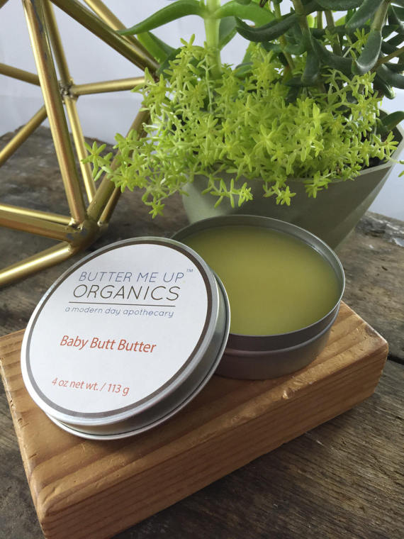 A 4oz tin of Baby Butt Butter, an organic diaper cream, featuring a creamy texture and natural ingredients like shea butter and coconut oil, ideal for soothing baby's skin.