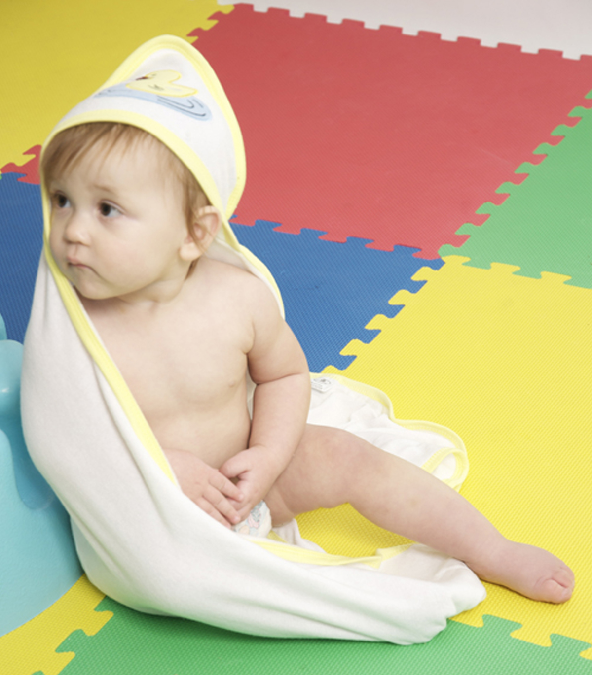 Two pink and white hooded infant bath towels, soft cotton blend, designed for comfort and warmth after bath time.