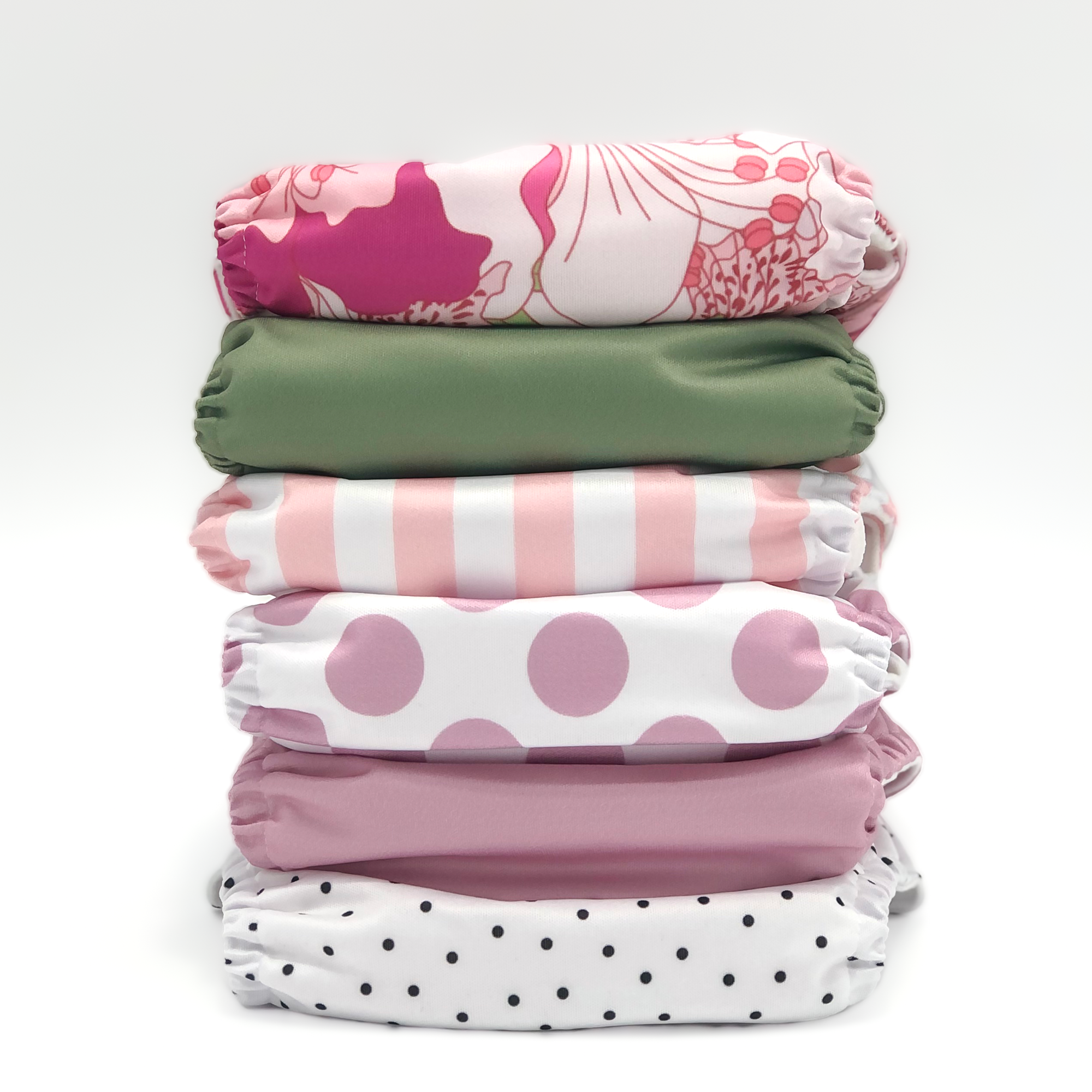 Jolie Fleur Cloth Diaper Collection featuring six stylish pocket diapers in vibrant prints including Hibiscus, Sage, Calathea, Dahlia, Lavender, and Tiger Lily.