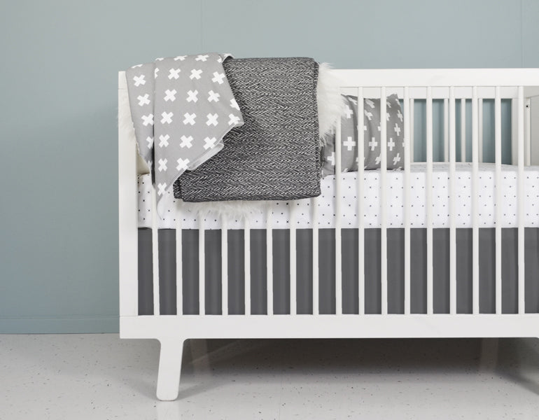 All My Hugs Classic Crib Bedding Set featuring a modern design with a charcoal blanket, fitted sheet, and crib skirt made from 100% organic cotton.