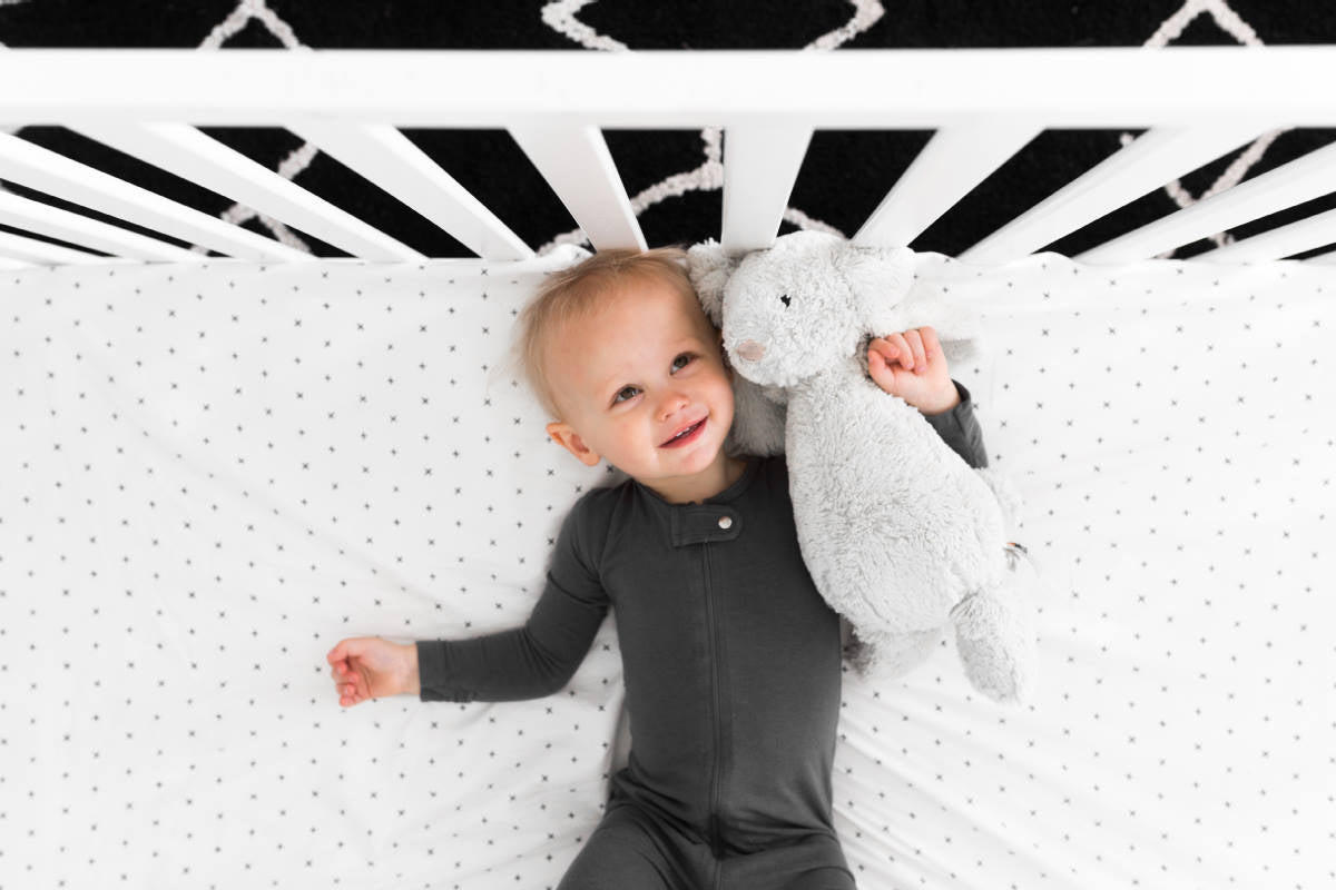 All My Hugs Classic Crib Bedding Set featuring a modern design with a charcoal blanket, fitted sheet, and crib skirt made from 100% organic cotton.