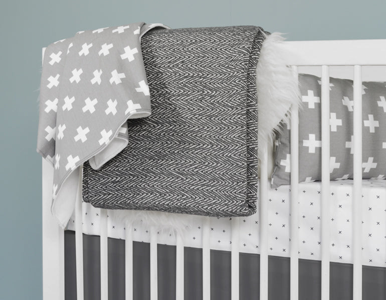 All My Hugs Classic Crib Bedding Set featuring a modern design with a charcoal blanket, fitted sheet, and crib skirt made from 100% organic cotton.