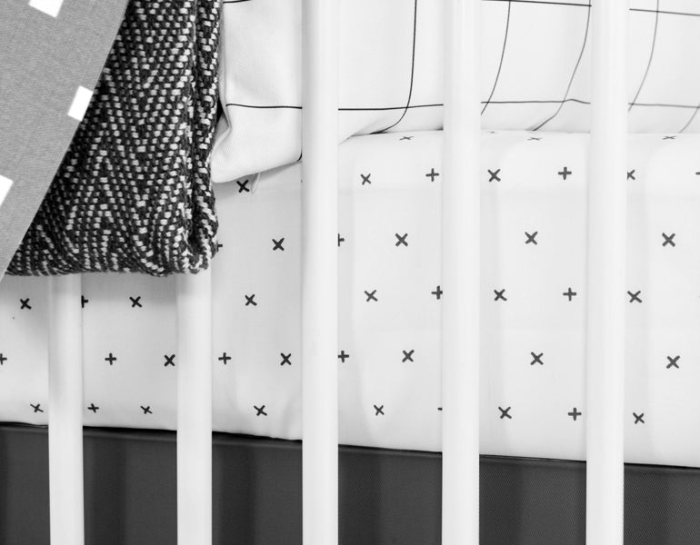 All My Hugs Classic Crib Bedding Set featuring a modern design with a charcoal blanket, fitted sheet, and crib skirt made from 100% organic cotton.