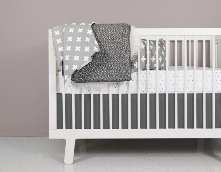 All My Hugs Classic Crib Bedding Set featuring a modern design with a charcoal blanket, fitted sheet, and crib skirt made from 100% organic cotton.