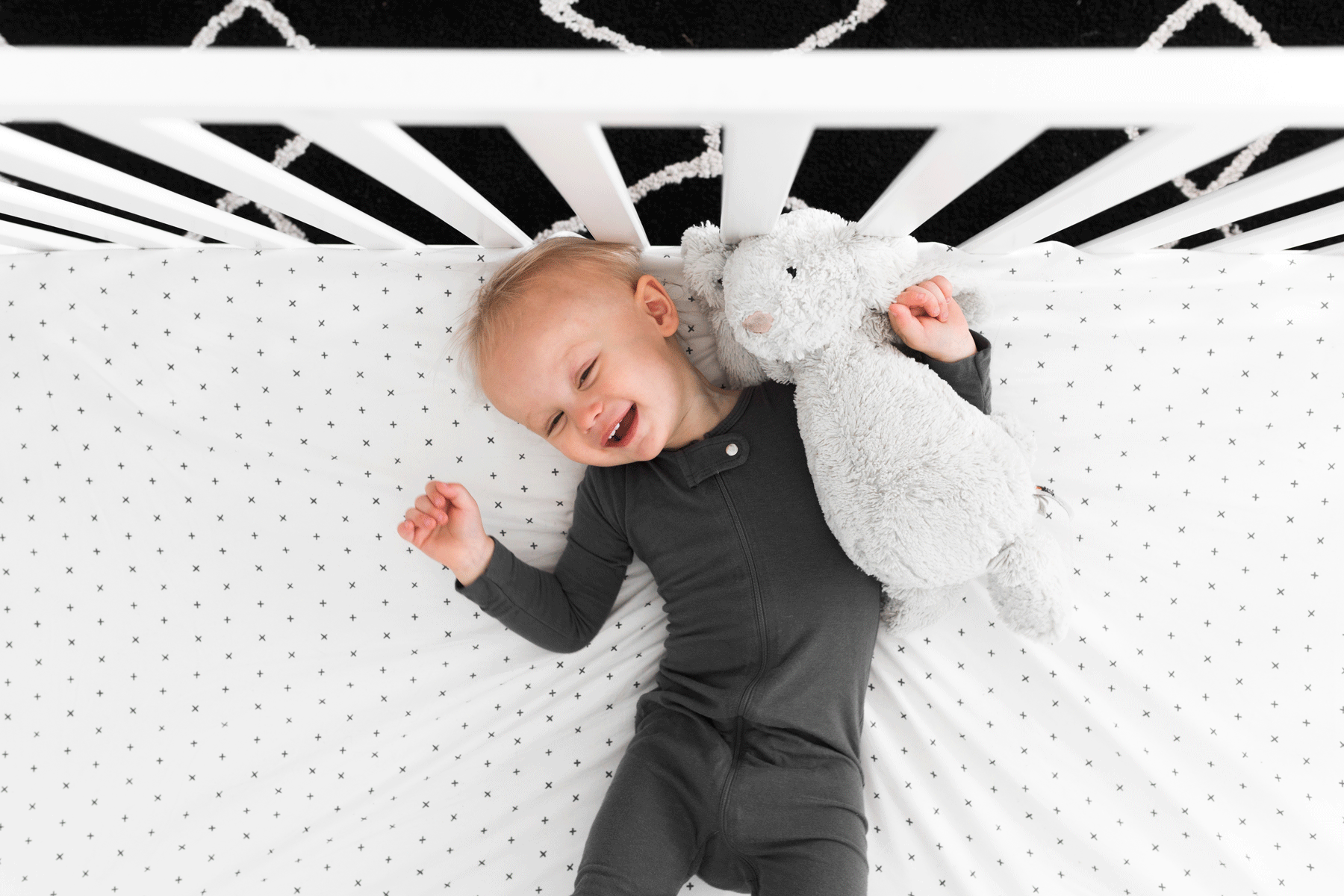 All My Hugs Classic Crib Bedding Set featuring a modern design with a charcoal blanket, fitted sheet, and crib skirt made from 100% organic cotton.