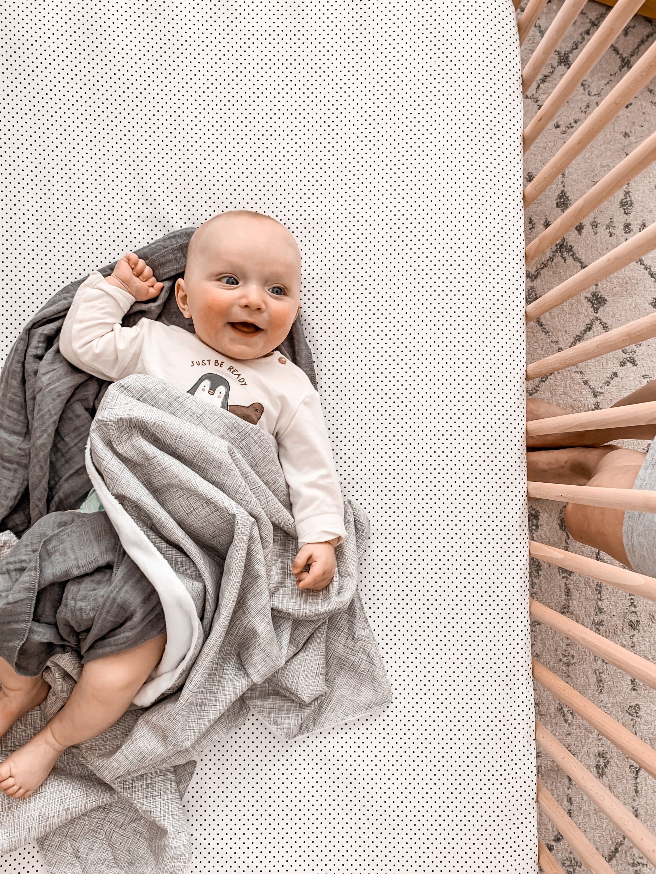 Avi Baby Blanket featuring modern design with neutral tones and playful lines, made from 100% cotton percale and soft minky fabric.