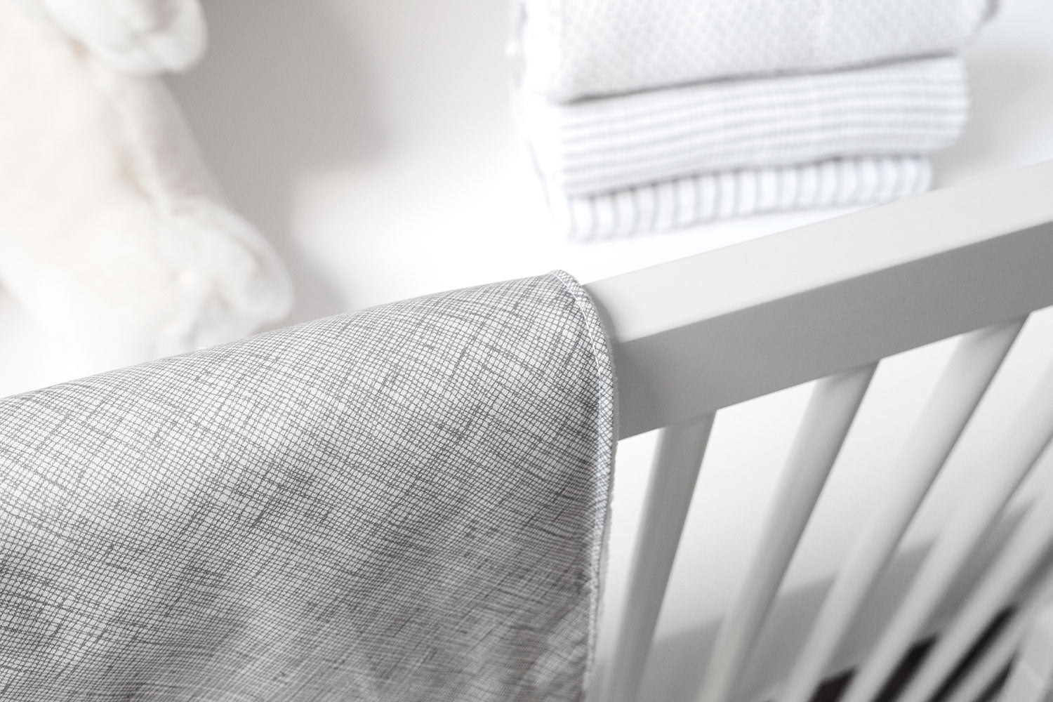 Avi Baby Blanket featuring modern design with neutral tones and playful lines, made from 100% cotton percale and soft minky fabric.