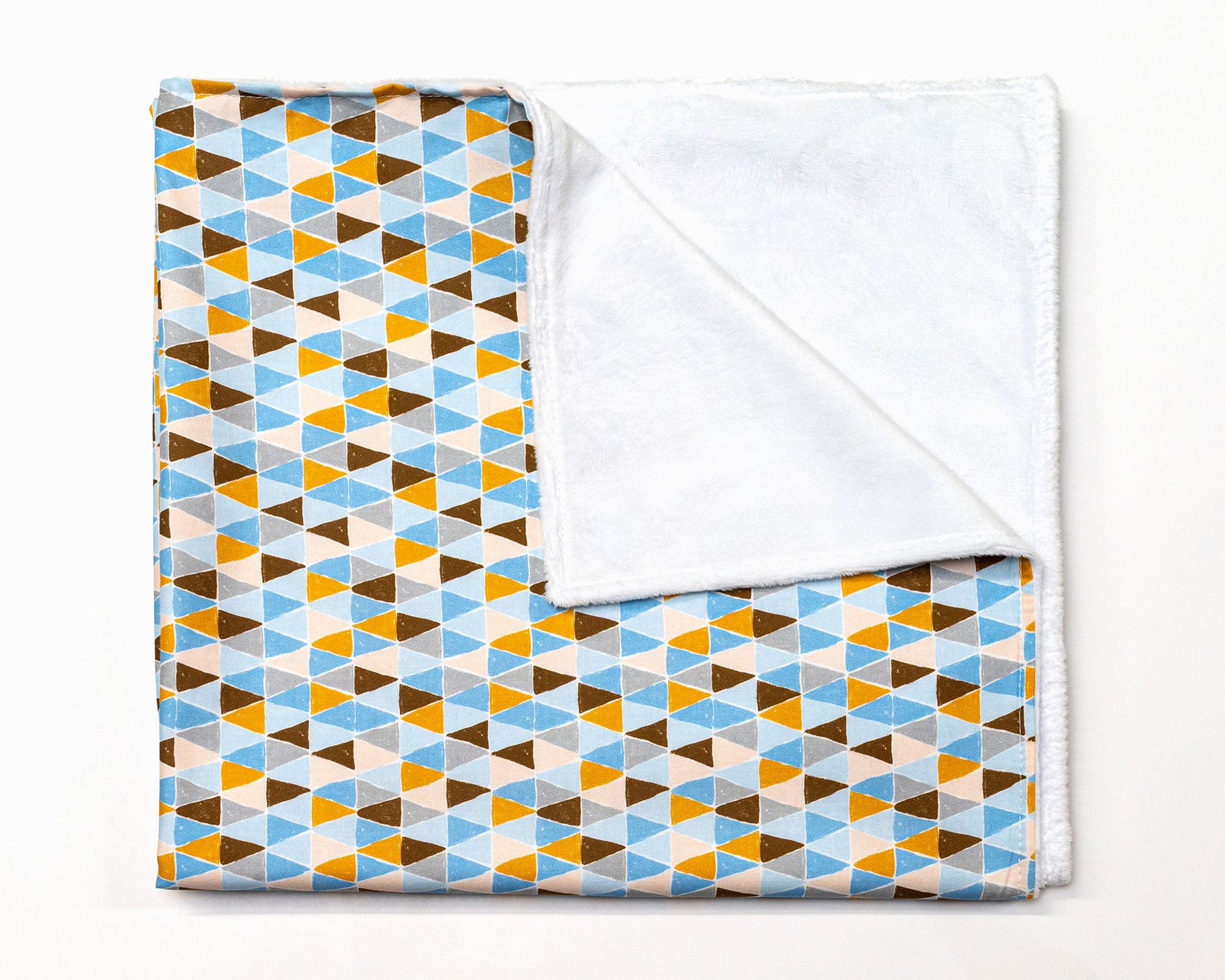 Blue Banners Marching Classic Crib Bedding Set featuring vibrant triangles in blue, brown, gray, and mustard colors, made from premium cotton.