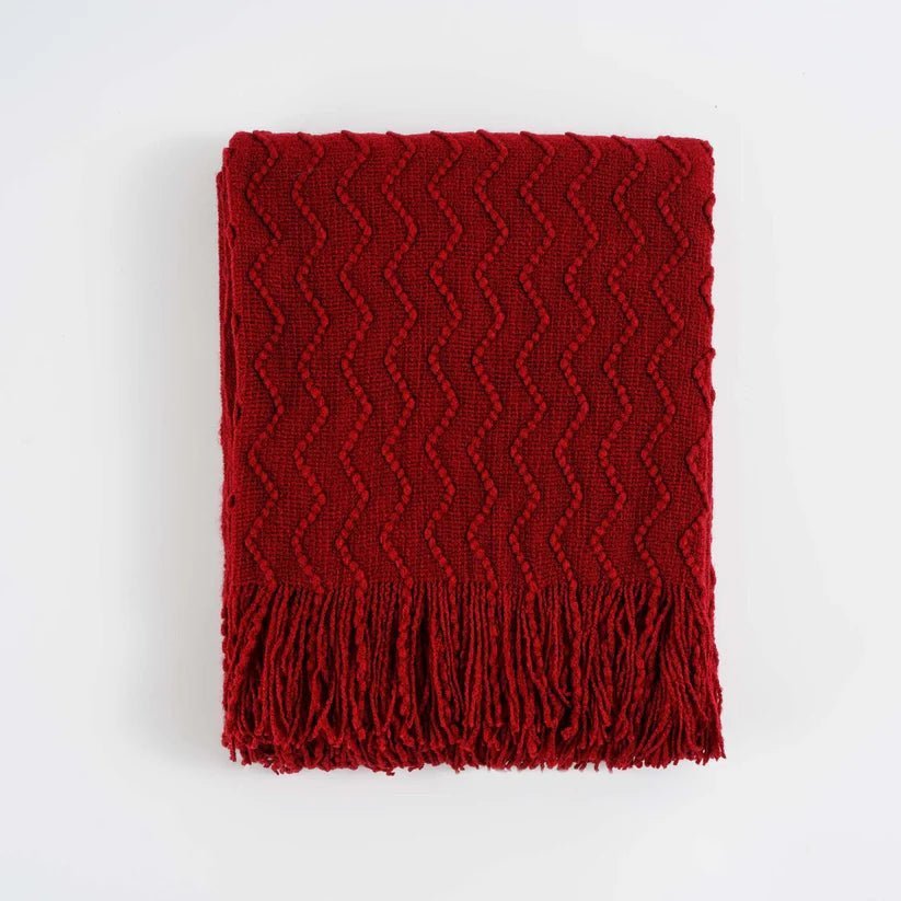 Chevron Fringe Throw blanket featuring a classic chevron pattern and stylish fringe detailing, perfect for home decor.