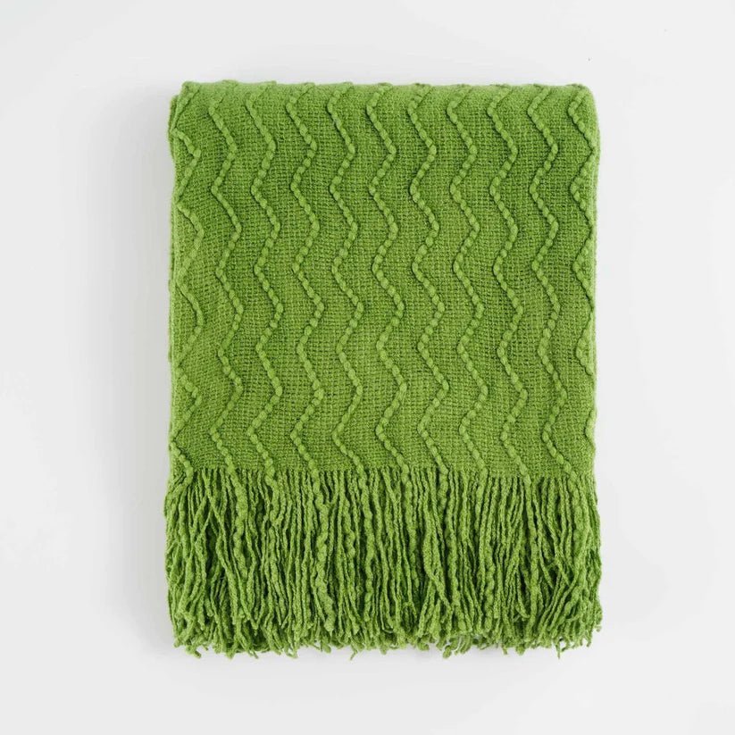 Chevron Fringe Throw blanket featuring a classic chevron pattern and stylish fringe detailing, perfect for home decor.