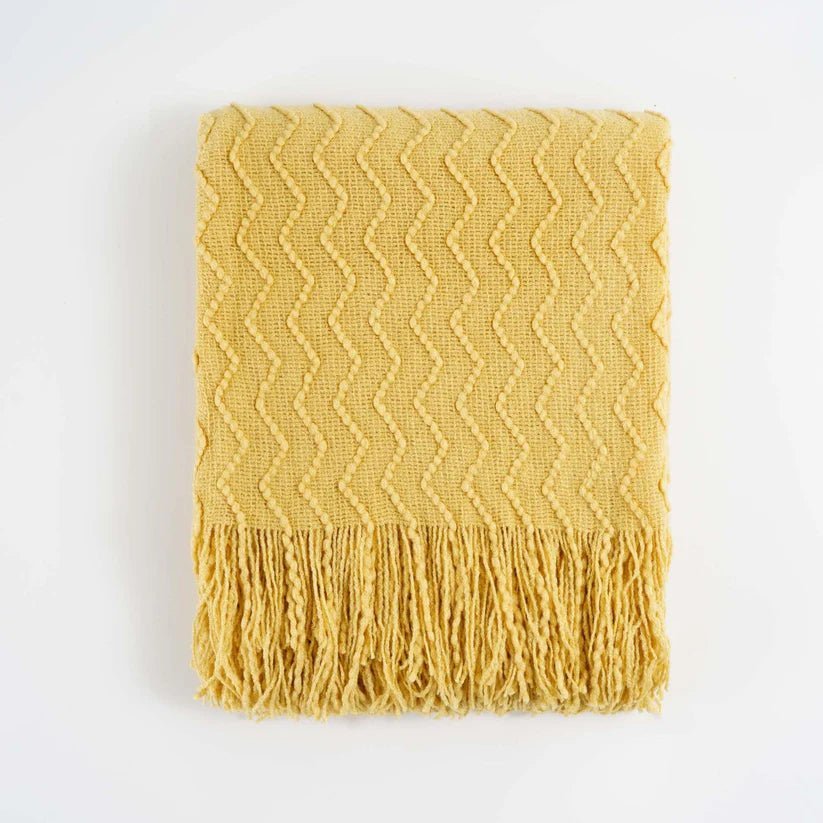 Chevron Fringe Throw blanket featuring a classic chevron pattern and stylish fringe detailing, perfect for home decor.