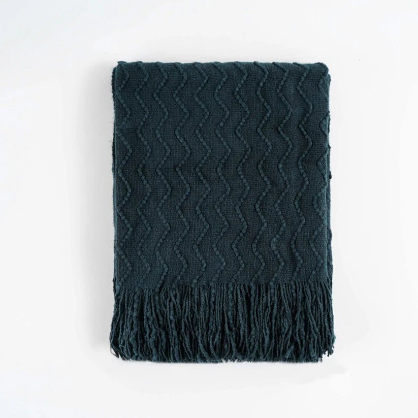 Chevron Fringe Throw blanket featuring a classic chevron pattern and stylish fringe detailing, perfect for home decor.