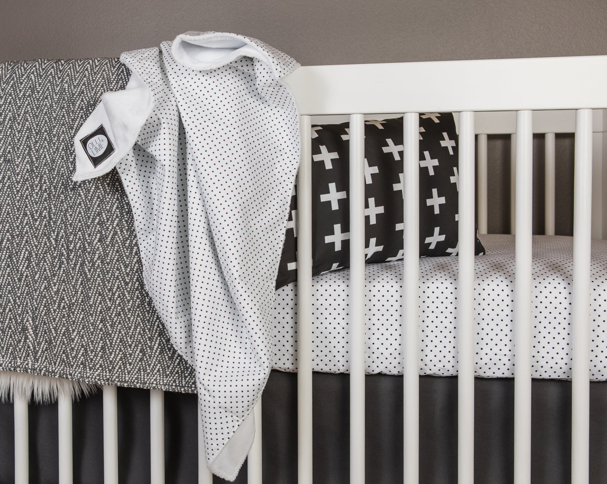 Connect the Dots Baby Blanket featuring a modern black and white dot design, made from 100% cotton percale with a soft minky backing.