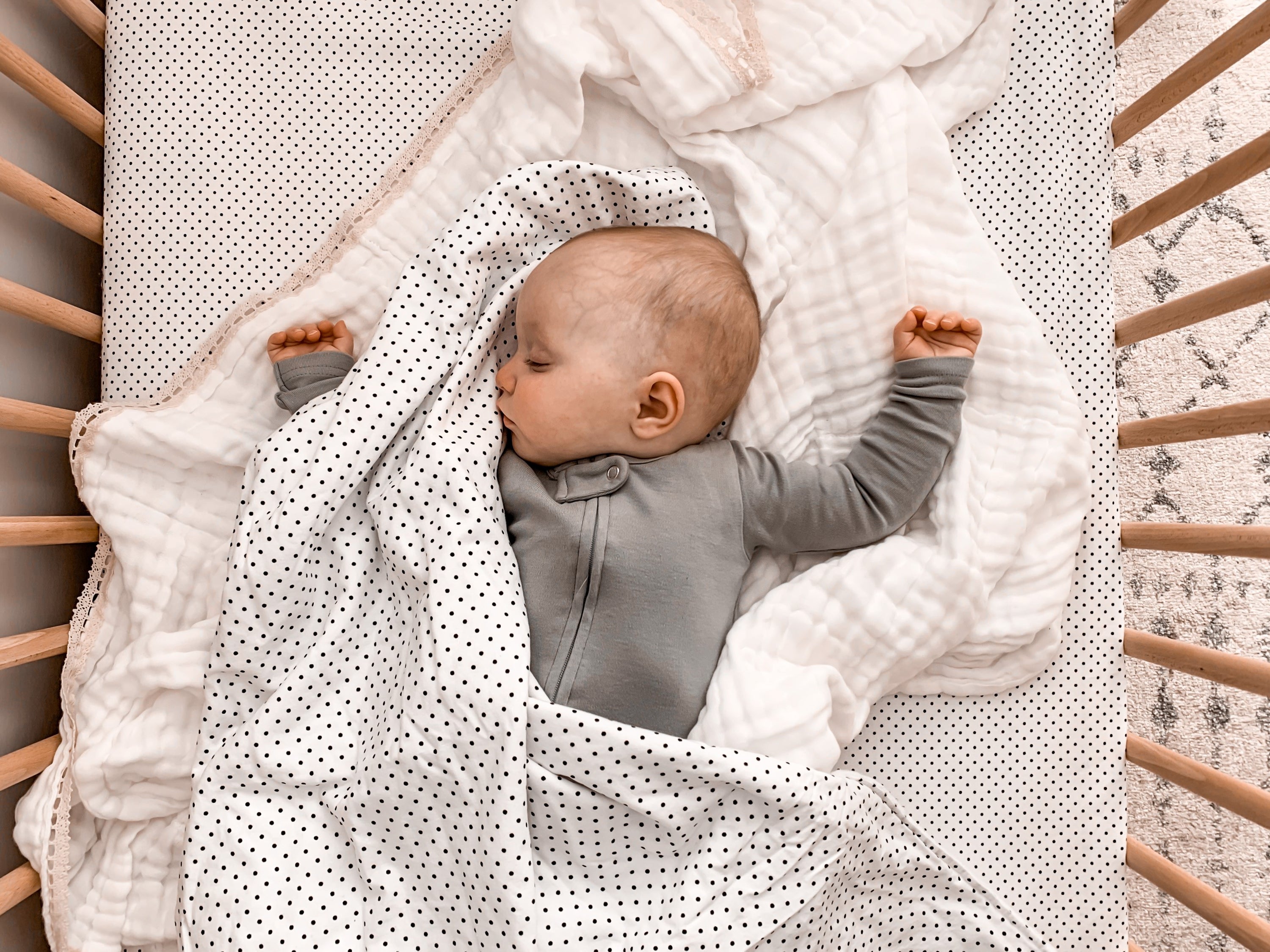 Connect the Dots Baby Blanket featuring a modern black and white dot design, made from 100% cotton percale with a soft minky backing.